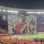Here are some alternate title suggestions for "Koreografi Berhias Tifo Pendekar Wayang Warnai Laga Indonesia vs China":

1. "Tifo Pendekar: Koreografi Penuh Warna pada Pertandingan Indonesia vs China"
2. "Paduan Tifo dan Wayang: Memeriahkan Duel Indonesia Melawan China"
3. "Kreativitas Tifo Pendekar: Menghiasi Pertarungan Indonesia vs China"
4. "Wayang dan Tifo: Seni Pertunjukan dalam Laga Indonesia vs China"
5. "Koreografi Tifo: Menyemarakkan Laga Epik Indonesia vs China"
6. "Pendekar Wayang dan Tifo: Simfoni Warna dalam Duel Indonesia vs China"
7. "Kekuatan Seni: Tifo Pendekar Memperkuat Semangat Indonesia vs China"
8. "Pesona Tifo Pendekar: Merayakan Laga Indonesia dan China"
9. "Seni dan Sportivitas: Tifo Pendekar Warnai Aksi Indonesia vs China"
10. "Menghidupkan Laga: Tifo dan Wayang Memperkuat Pertarungan Indonesia vs China"

Feel free to mix and match phrases from these titles to find the perfect fit!